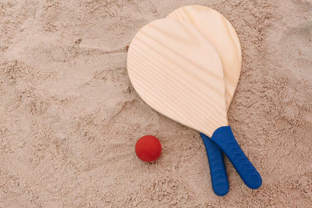 Ping pong na plaży Paletki od ping ponga leżące na piasku